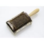 A George III period ivory and silver table nutmeg grater, the curved steel grate with silver mounts,