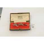 An Edwardian diamond set gold sweetheart brooch, of arrow form, the shaft with entwined hearts