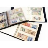 Three albums of world bank notes, one starting with Argentina, then Brazil, and moving to Peru,