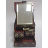 A Meiji period scarlet ground dressing table box decorated with birds and butterflies, the lid