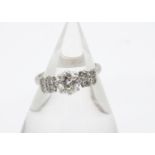 A diamond dress ring, the old cut diamond in claw setting approximately 0.90ct, flanked by eight old