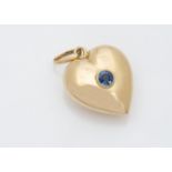 An 18ct gold yellow metal and sapphire heart pendant, the heart centred with circular mixed cut