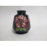 A contemporary Moorcroft pottery vase, of bulbous form, a trial piece with tube lined decoration