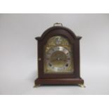 An 18th Century style mahogany cased bracket clock by Elliott, the arched brass dial with a '