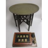 A table with Middle Eastern brass top, with various foliate, animal and script borders, diameter