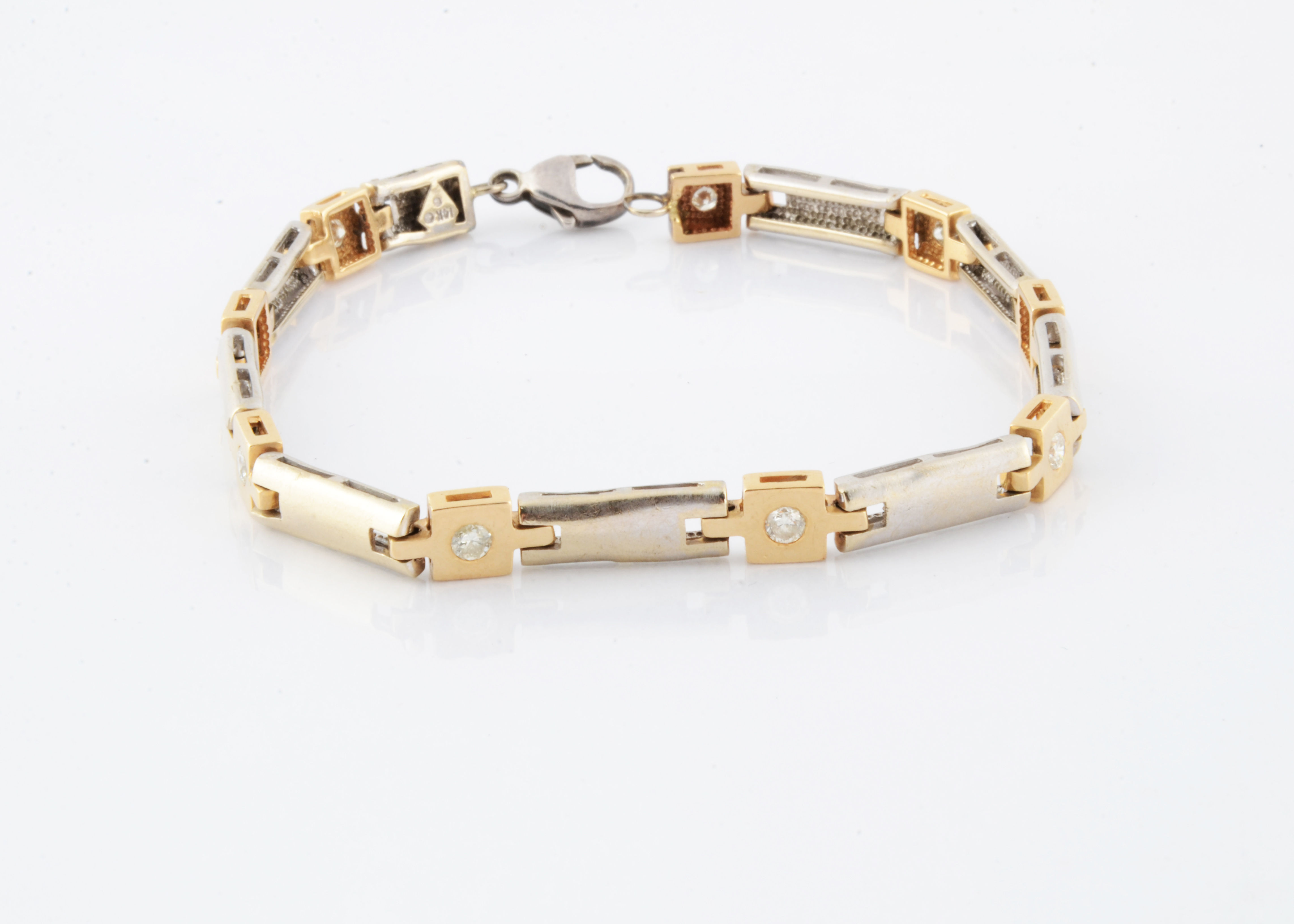 A gentleman's 14ct two colour gold diamond bracelet, the white metal batons alternately set with