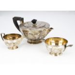 An Art Deco period silver three piece tea set by Goldsmiths & Silversmiths, stylish squat form,