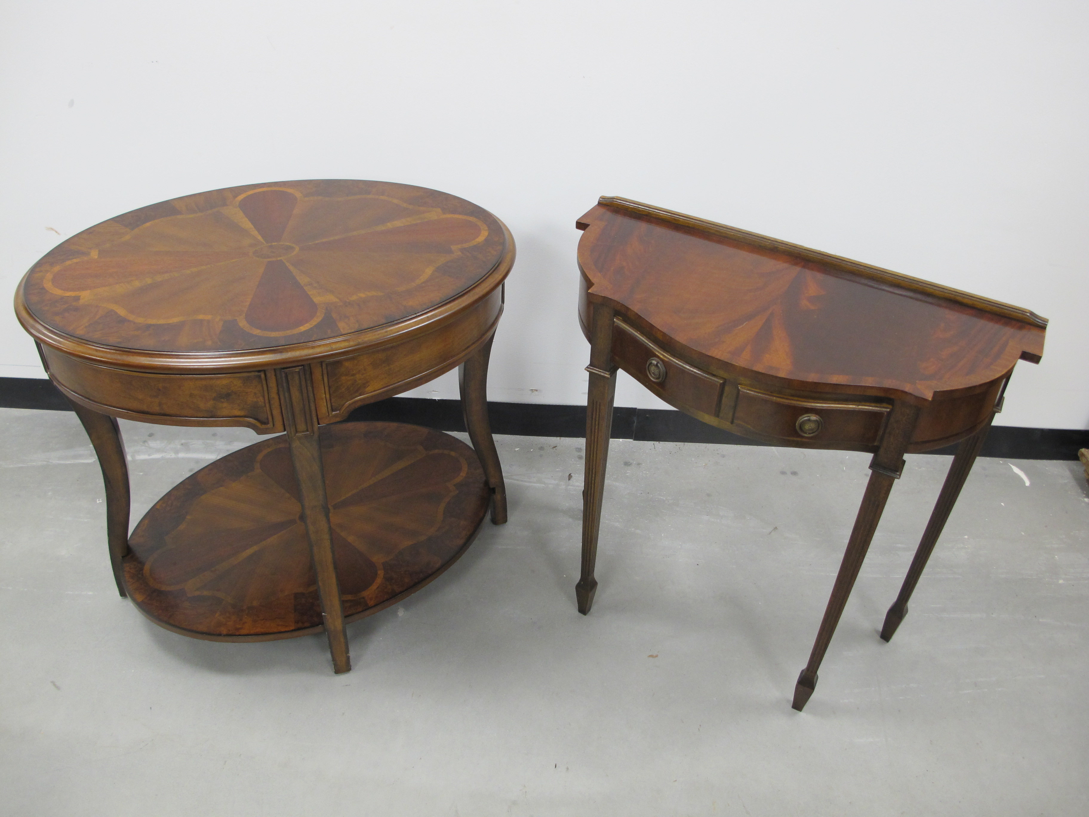 A contemporary mahogany and walnut two tier oval centre table, inlaid fan design to top and lower