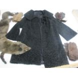 A 1950s lady's Astra Furs of Paris coat, made of black lambs wool with a black silk interior,