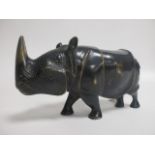 A 20th Century bronze model of a rhino, unsigned, height 12.5cm, length 24cm