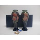 Two Moorcroft vases, of inverted baluster form, in the 'Pomegranate and Finches' pattern, with
