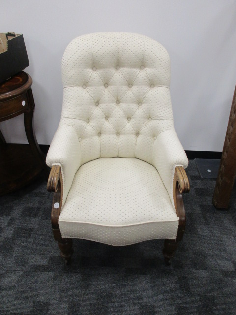 A 19th Century button back armchair, with oak scroll arms and turned supports, upholstered in an