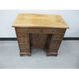 A 19th Century mahogany kneehole desk of small proportions, with moulded top, with two long