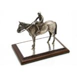A 1990s silver horseracing desk ornament by W&W, naturalistically modelled stood with a jockey on