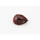 A 19th Century Bohemian garnet brooch, of pear shape with central cabochon surrounded by two bands