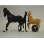 A Royal Doulton figure of a horse, together with two Beswick examples and a novelty pin pot , the