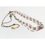A mid 20th Century Indian multi strand ruby, emerald and seed pearl necklace, the polished emerald