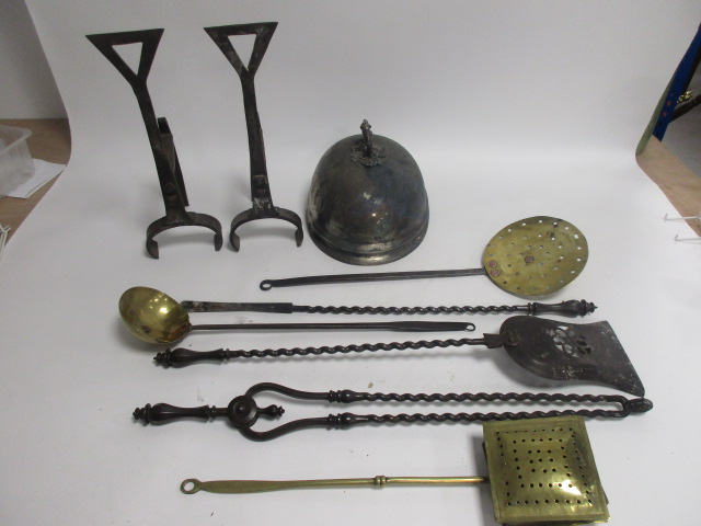 A collection of metalware, including pieces from a fireside companion set, a serving dish dome and