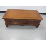 A contemporary hardwood coffee table, with two long drawers to either side, with steel fittings,