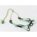 An emerald five strand necklace, on a silk and gold thread adjustable cord, emerald beads in