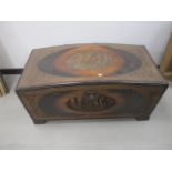 A domed top Oriental camphor wood trunk, with central carving to top and front panel depicting