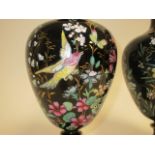 A pair of Victorian Jackfield black pottery vases, with hand painted decoration of birds amidst