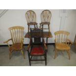 A late 19th Century oak and elm elbow chair, with carved back panel and rail, red studded upholstery