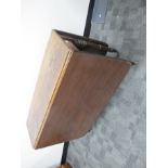 An antique mahogany drop flap table, rounded corners, raised on turned supports, finished on brass