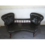 Victorian Rosewood Boudoir Sofa, in later green leather with two buttoned back rests joined by a
