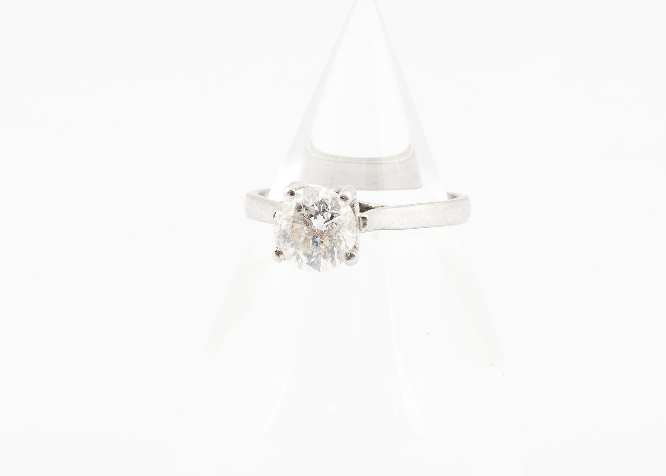 An 18ct gold diamond solitaire ring, the brilliant cut in four claw setting on a white 18ct gold