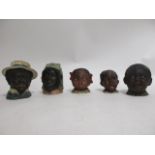 Five early 20th Century caricature tobacco jars, to include a young wide eyed girl, height 10cm (5)