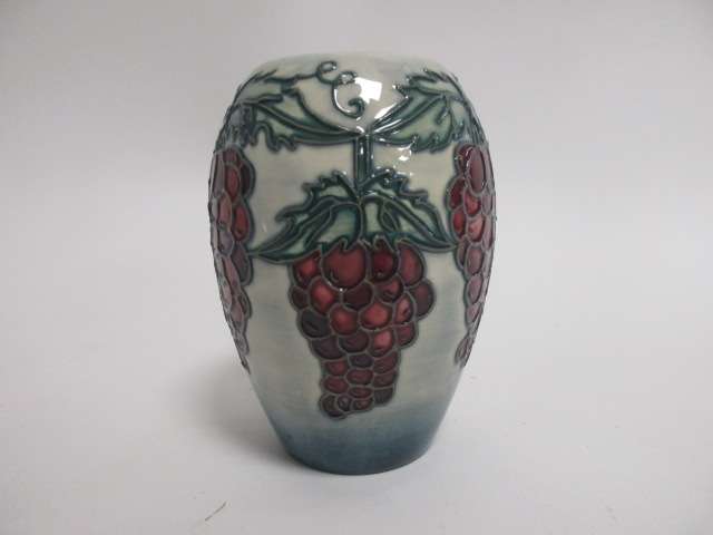 A contemporary Moorcroft pottery vase, a trial piece with tube lined decoration of red grapes upon a - Image 2 of 3