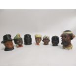 Seven early 20th Century novelty caricature tobacco jars, to include a tribal figure with a tooth