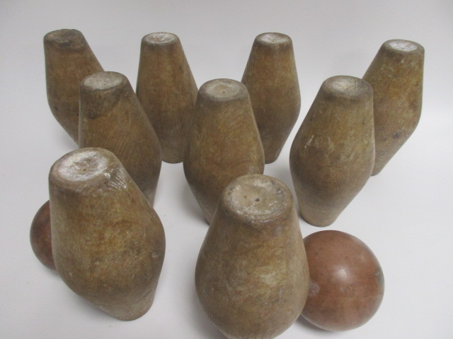 A set of nine early 20th Century turned wooden skittles, together with two balls (11)