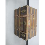 An early 20th Century wooden bound travel trunk, with lift out tray to the interior and lined with