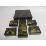 An Oriental lacquered box with gilt decoration of figures with umbrellas, boats and bridges, the