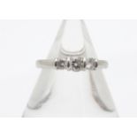 A platinum and diamond three stone ring, the brilliant cuts in bracket setting, on a rounded