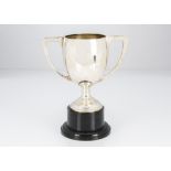 A George V period silver twin handled trophy cup, 10 ozt, on black Bakelite style base, not