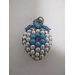 An early 20th Century pearl, turquoise and ruby heart pendant, the heart encrusted with half