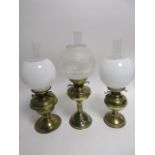 Three early 20th Century brass oil lamps, one a Duplex marked example, another by Sherwoods of