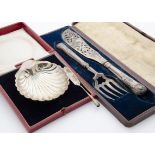 A George V silver shell butter dish and spoon in case and plated item, together with a cased set