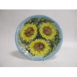 A contemporary Moorcroft pottery charger, of circular form, in the 'Sunflower' pattern designed by