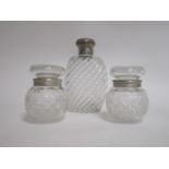 A William Comyns decanter c1887, height 19cm, together with two silver rimmed bulbous jars,