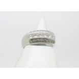 A continental white metal diamond set dress ring, the central band of six princess cuts, flanked