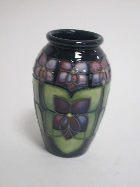 A contemporary Moorcroft pottery vase, of ovoid form, in the 'Violet' pattern designed by Sally