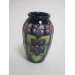 A contemporary Moorcroft pottery vase, of ovoid form, in the 'Violet' pattern designed by Sally