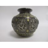 An Indian metalwork pot, having brass and silver colouring, with multiple cartouches of deities,