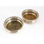 A pair of Victorian silver plated wine bottle coasters