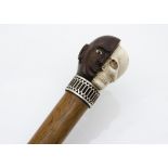 A fine Victorian walking cane, having blackamoor rosewood carved half head, with the other side as a
