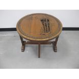 A 20th Century Oriental circular tilt top table, with folding base, the top carved with bamboo